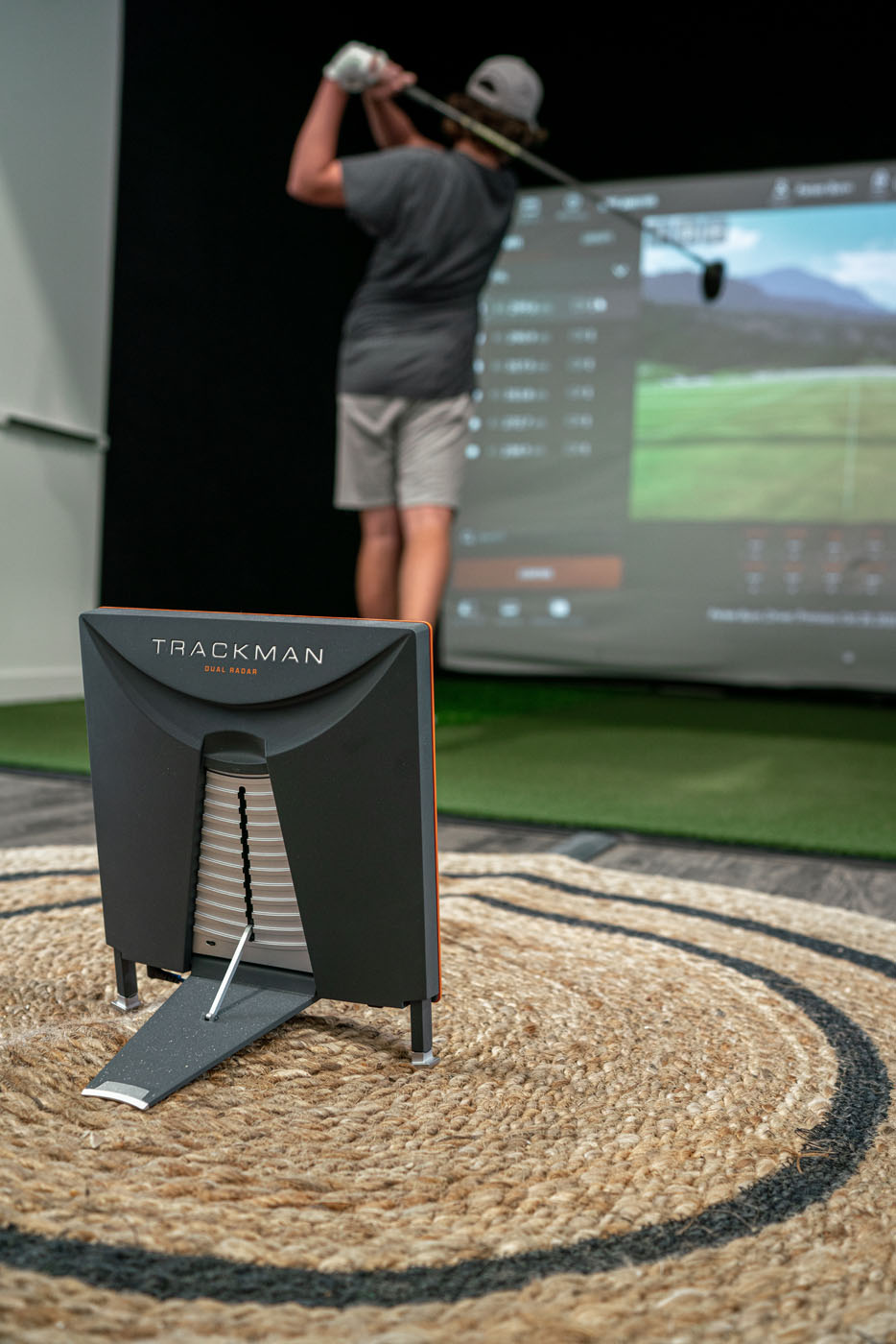 A Tee Box member practicing his golf swing on our trackman technology, learn about our virtual golf costs.
