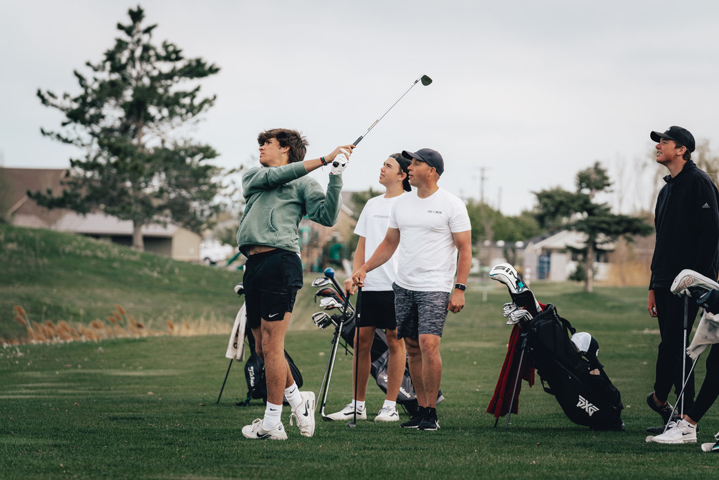 A group of beginning golfers learning from one of Tee Box's private classes.